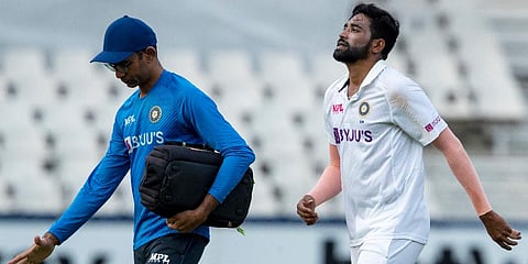 India's Mohammed Siraj, right, leaves the field with team physio Nitin Patel during the day 1 of their 2nd Test Cricket match against South Africa at the Wanderer's Stadium, Jan 3, 2022. (Photo | AP)