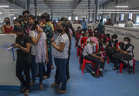 Indian teens wait to receive vaccination for COVID-19 at a vaccination center in Mumbai, India, Monday, Jan. 3, 2022. (Photo | AP)