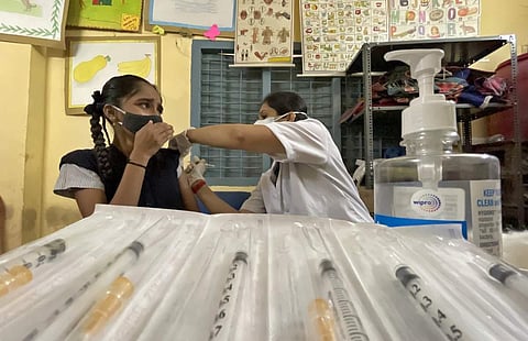 A health worker administers a COVID-19 vaccine to a teenager. (Photo | Express)