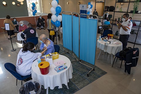 A man receives his fourth dose of the coronavirus vaccine in a private nursing home in Petah Tikva, Israel, Tuesday, Jan. 4, 2022. (AP)