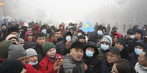 monstrators, one of which holds a police ammunition, gather during a protest in Almaty, Kazakhstan.(Photo | AP)