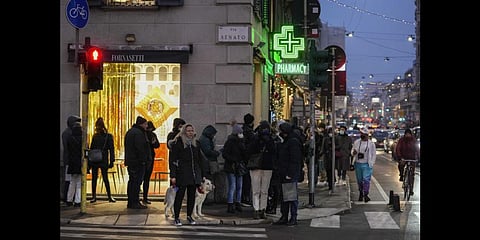 People line up outside a pharmacy for COVID-19 swab tests, in front of Milan's Duomo gothic cathedral, Italy. (Photo | AP)