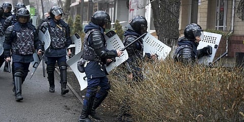Riot police walk to block demonstrators during a protest in Almaty, Kazakhstan amid protests against soaring gas prices. (Photo | AP)