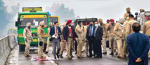 Police personnel and officials on the flyover where Prime Minister Narendra Modi’s convoy was stuck due to a blockade. (Photo | EPS)