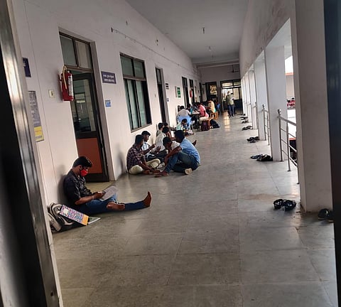 Examination aspirants sit at the floor at Tiruchy Central Library to study. (Photo | Express)