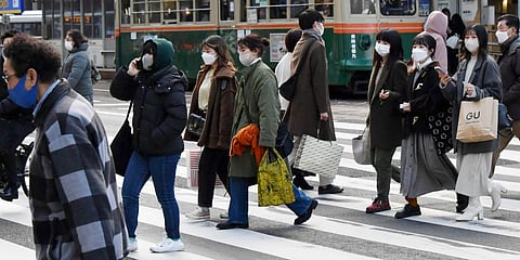 People wearing face masks cross a street in Hiroshima, western Japan. (Photo | AP)