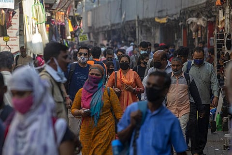 People wearing face masks as a precaution against the coronavirus walk outside a railway station in Mumbai, India, Tuesday, Jan. 4, 2022. (Photo | AP)