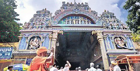 As entry of devotees is prohibited in places of worship on Fridays, Saturdays and Sundays owing to the pandemic situation, people offered prayers outside Meenakshiamman Temple in Madurai on Friday | K