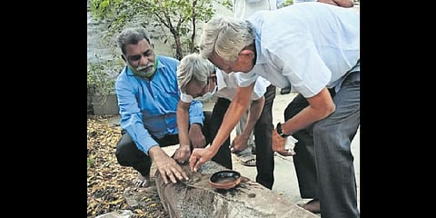 Researchers inspect the Kalamalla inscription in Kadapa district. (Photo| Express)