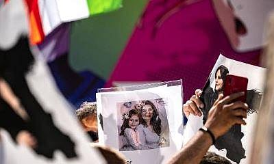 People chant slogans and hold pictures of Mahsa Amini during the 'Freedom rally for Iran' event in the Shibuya district of Tokyo on October 1, 2022. (Photo | AFP)