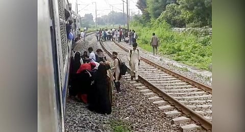 Worried passengers alight from an MMTS train when it suddenly stopped between Begumpet and Necklace Road railway stations on Friday.