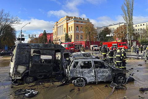 Rescue workers survey the scene of a Russian attack on Kyiv, Ukraine on Monday, Oct. 10, 2022. (Photo | AP)