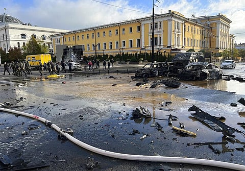 Rescue workers survey the scene of a Russian attack on Kyiv, Ukraine on Monday, Oct. 10, 2022. (Photo | AP)