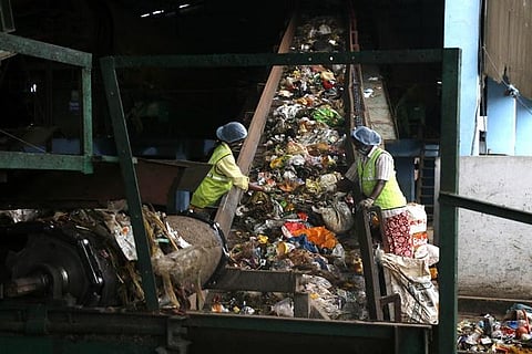 Workers Segregating garbage at Vellalore dump yard in Coimbatore. (Photo | S Senbagapandiyan)