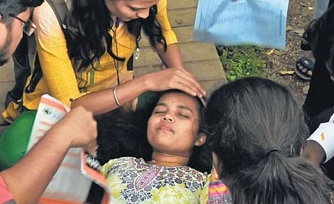 Students try to revive their friend who fainted during the protest