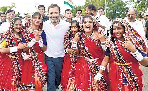 Lambani women from Davanagere district are thrilled to shake a leg with Congress leader Rahul Gandhi during the Bharat Jodo Yatra on Wednesday | Express