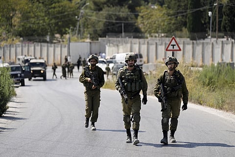Israeli military forces work near the site where a soldier was killed by gunfire near the West Bank Jewish settlement of Shavei Shomron. (Photo | AP)