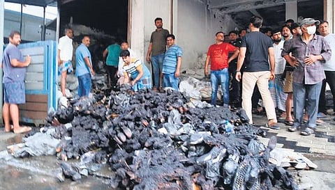 A heap of burnt footwear outside the company near Pottakuzhy which got gutted due to an electric short circuit on Thursday | Express