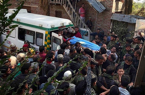 People carry the body of Puran Krishan Bhat, who is from the minority community of Kashmiri Hindus, outside his home in in southern Shopian district. (Photo | AP)
