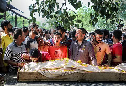 Family members and relatives of Puran Krishan Bhat, a Kashmiri Pandit who was shot dead allegedly by militants in Shopian, during his funeral in Jammu. (Photo | PTI)