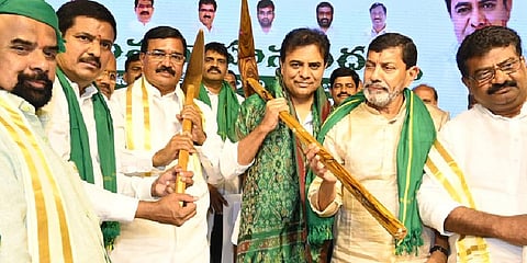 Minister K T Rama Rao with farmers at Manneguda in Ibrahimpatnam mandal on Saturday 