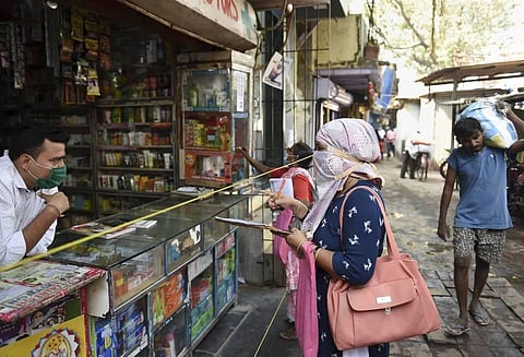 In this representational image, health department workers interact with a shopkeeper during a door to door survey for tuberculosis and leprosy at Dharavi in Mumbai. (File Photo | PTI)