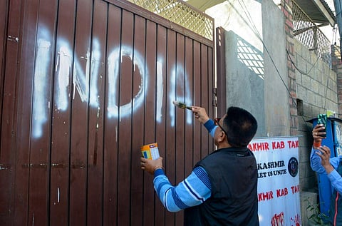 Kashmiri Pandits along with social activists vandalise the board at All Parties Hurriyat Conference office. (Photo | PTI)
