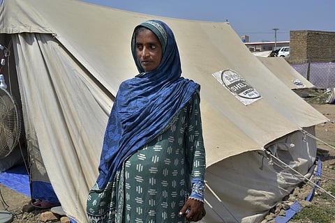 Shakeela Bibi who is pregnant stands beside her tent at a relief camp for flood victims, in Fazilpur near Multan, Pakistan, Sept. 23, 2022. (Photo | AP)