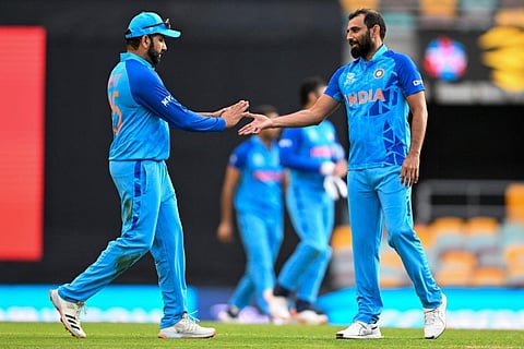 Indian captain Rohit Sharma gestures to teammate Mohammed Shami following the ICC T20 World Cup warm-up cricket match between Australia and India in Brisbane. 