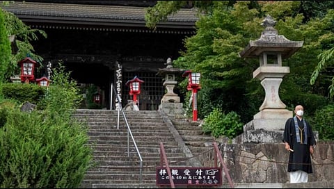 Buddhist monk Tesshu Inoue (R) standing outside the entrance to Daizenji temple, nicknamed the 'grape temple'. (Photo | AFP)