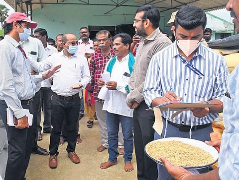 Members of the Central team assessing the moisture content of paddy procured at a DPC in Melanagore in Nagapattinam district on Sunday | Express