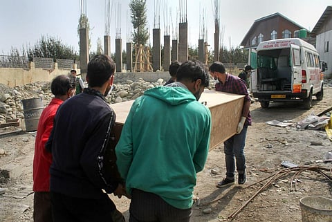 Mortal remains of one of the two migrant labourers killed during a grenade attack by terrorists being carried to an ambulance, in Shopian district. (Photo | PTI)