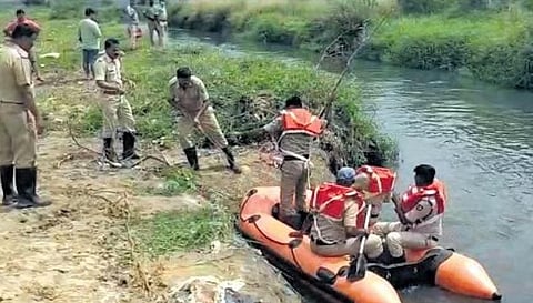 Fire personnel search for 3-year-old Kabir who allegedly drowned in a drain, in Varthur limits, in Bengaluru on Tuesday