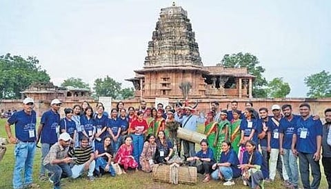 Volunteers pose in front of the Ramappa temple