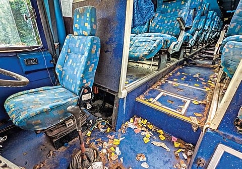 Scene inside an abondoned bus at OSRTC depot in Khandagiri, littered with used condoms (Below) Passengers waiting at the bus depot | Express