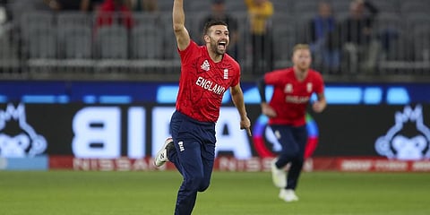 England's Mark Wood celebrates after taking the wicket of Afghanistan's Rahmanullah Gurbaz during the T20 World Cup cricket match between England and Afghanistan in Perth.