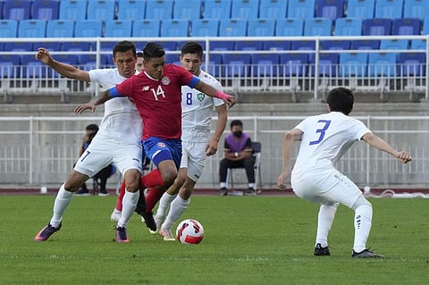 Costa Rica's Orlando Galo fights for the ball against Uzbekistan's Otabek Shukurov during a friendly soccer match in Suwon, South Korea. (Photo | AP)