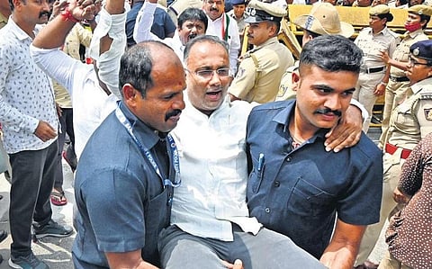 Congress leader Dinesh Gundu Rao being detained by the police during a protest against the pothole menace, in Bengaluru on Friday | Shashidhar Byrappa