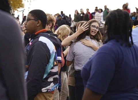 People gather outside after a shooting at Central Visual and Performing Arts high school in St. Louis, on Monday, Oct. 24, 2022. (Photo | AP)
