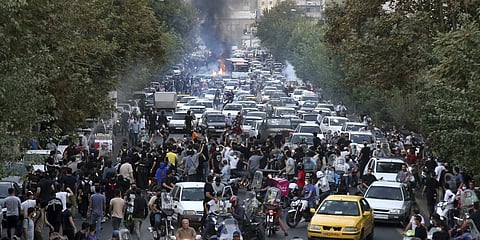 In this representative image, protesters chant slogans during a protest over the death of Mahsa Amini who was detained by the morality police, in downtown Tehran, Iran.(File Photo | AP)