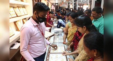 People checking out gold ornaments at a jewellery shop in Bhubaneswar. (Photo | Express)