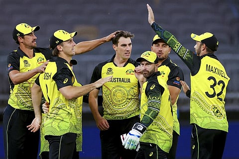 Pat Cummins, centre, of Australia is congratulated by teammates after dismissing Kusal Mendis of Sri Lanka during the T20 World Cup cricket match between Australia and Sri Lanka in Perth. (Photo | AP)