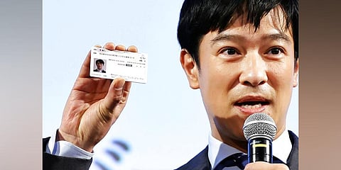 Japanese actor Masato Sakai shows a sample of My Number card during a promotional event in Tokyo on March 8, 2021. J(Photo | AP)