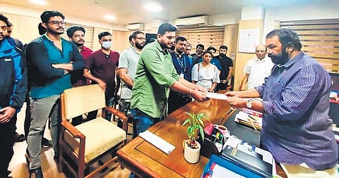 Employees of Byju’s and Prathidwani representatives hand over a memorandum to Labour Minister V Sivankutty on Tuesday