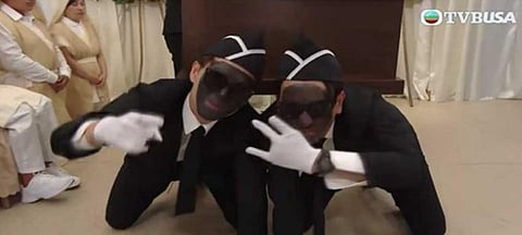 In an episode of 'Come Home Love: Lo and Behold', four people are seen wearing black make-up while singing and dancing as they carry a coffin out of a room at a memorial. (Screengrab)