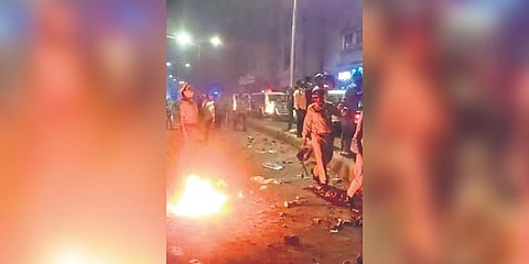 Police personnel at the site of the clashes in Vadodara.