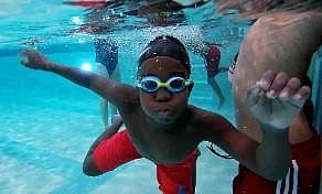 A student of Bishop John T. Walker School for Boys attends a free swimming lesson at Ferebee-Hope Aquatic Center in Washington | AFP