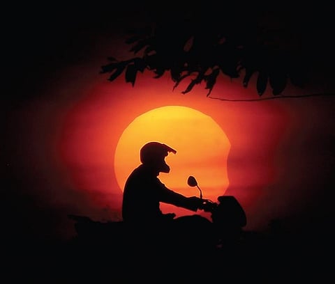 A man pictured against the solar eclipse, on the outskirts of  Bhubaneswar, on Tuesday | DEBADATTA MALLICK