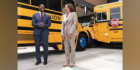 Vice President Kamala Harris laughs with Environmental Protection Agency Administrator Michael Regan, during a tour of electric school buses at Meridian High School in Falls Church (Photo | AP)