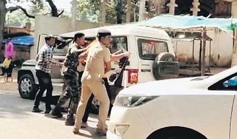 Video grab of police stopping BJP workers from showing black flags to Minister Sahu